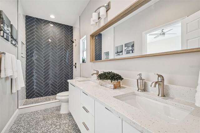 6433 Werner Ave, New Port Richey, FL 34652 - bathroom with double vanity, toilet, a shower stall, a ceiling fan, and tile patterned floors