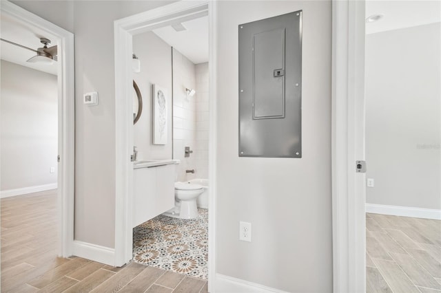6433 Werner Ave, New Port Richey, FL 34652 - bathroom featuring electric panel, wood finish floors, baseboards, vanity, and shower / bathtub combination