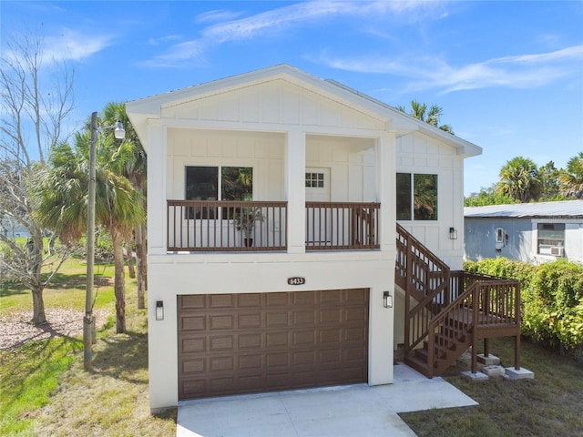 6433 Werner Ave, New Port Richey, FL 34652 - coastal home featuring a garage, board and batten siding, concrete driveway, and stairs