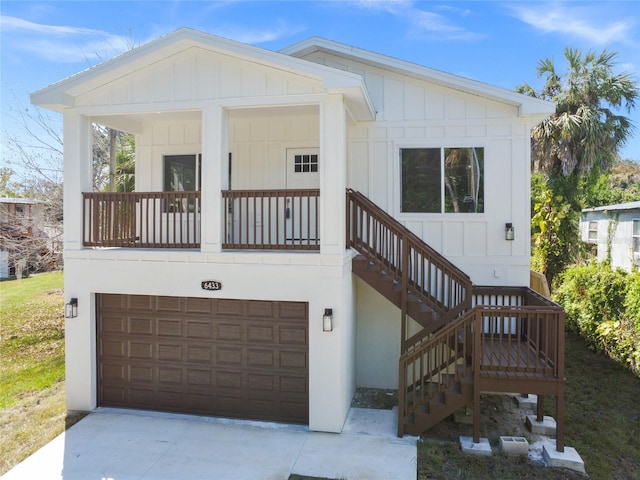 6433 Werner Ave, New Port Richey, FL 34652 - view of front facade featuring a garage, board and batten siding, concrete driveway, and stairway