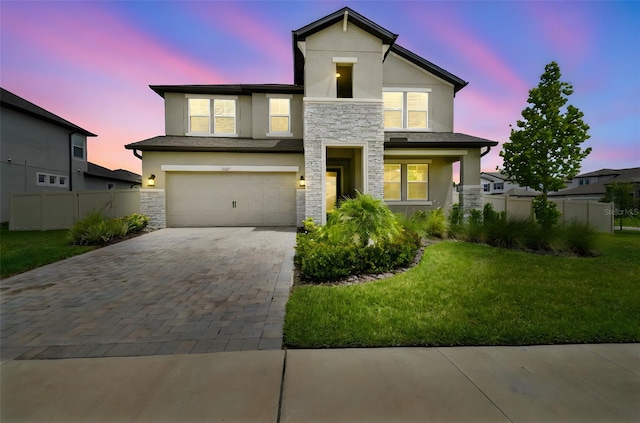 33287 Sycamore Leaf Dr, Wesley Chapel, FL 33545 - view of front facade featuring stone siding, stucco siding, decorative driveway, and an attached garage