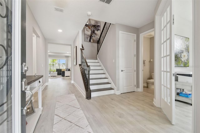 33287 Sycamore Leaf Dr, Wesley Chapel, FL 33545 - entrance foyer featuring stairway, light wood-style floors, french doors, baseboards, and recessed lighting