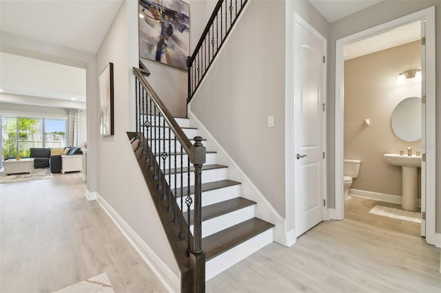 33287 Sycamore Leaf Dr, Wesley Chapel, FL 33545 - stairway with wood finished floors and baseboards