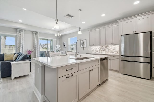 33287 Sycamore Leaf Dr, Wesley Chapel, FL 33545 - kitchen featuring stainless steel appliances, a sink, light countertops, light wood-type flooring, and recessed lighting
