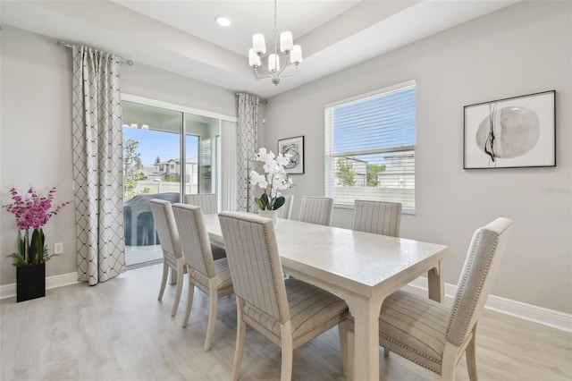 33287 Sycamore Leaf Dr, Wesley Chapel, FL 33545 - dining room featuring a chandelier, light wood-style flooring, and baseboards