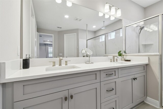 33287 Sycamore Leaf Dr, Wesley Chapel, FL 33545 - full bathroom featuring double vanity, a marble finish shower, and recessed lighting