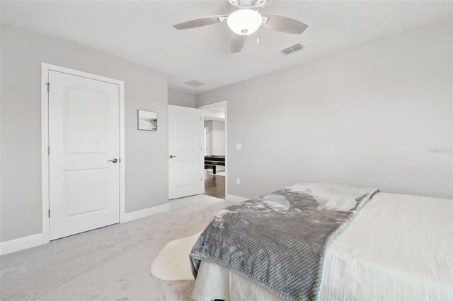 33287 Sycamore Leaf Dr, Wesley Chapel, FL 33545 - bedroom with light colored carpet, baseboards, and a ceiling fan