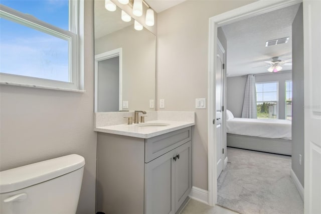 33287 Sycamore Leaf Dr, Wesley Chapel, FL 33545 - bathroom featuring vanity, toilet, ensuite bathroom, a ceiling fan, and baseboards