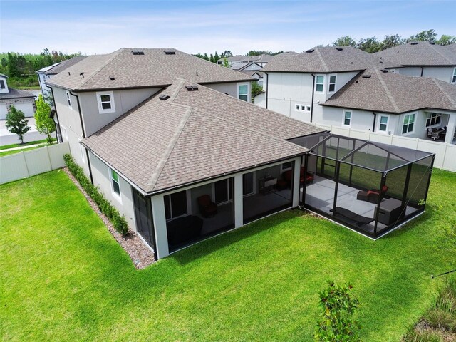 33287 Sycamore Leaf Dr, Wesley Chapel, FL 33545 - back of property with a shingled roof, a patio, a sunroom, and stucco siding