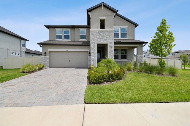 33287 Sycamore Leaf Dr, Wesley Chapel, FL 33545 - view of front facade featuring stucco siding, stone siding, decorative driveway, and an attached garage