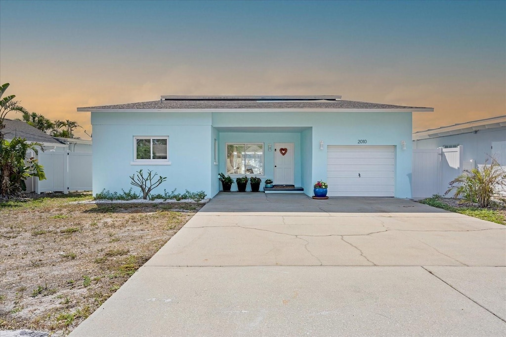 2010 20th Avenue Parkway, Indian Rocks Beach, FL 33785 - view of front of house with stucco siding, a garage, and driveway