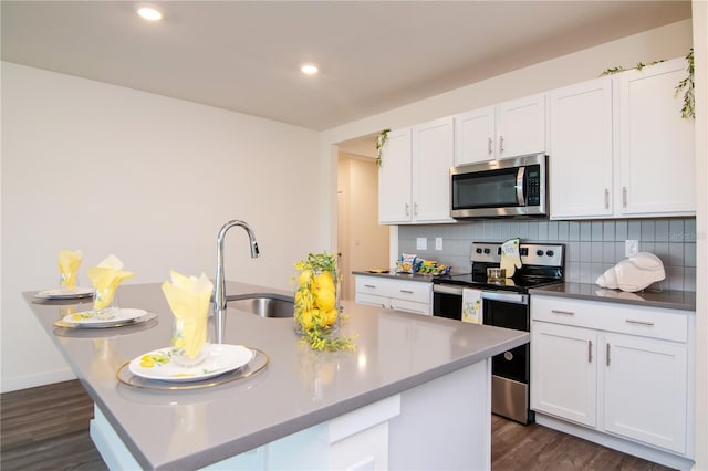 9795 Crescent Ray Dr, Wesley Chapel, FL 33545 - kitchen with stainless steel appliances, a sink, decorative backsplash, white cabinetry, and dark wood-style floors