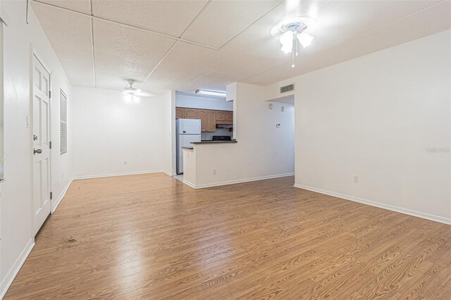 4708 Michael Ct Unit 104, Tampa, FL 33614 - unfurnished living room featuring a ceiling fan, light wood-type flooring, and baseboards