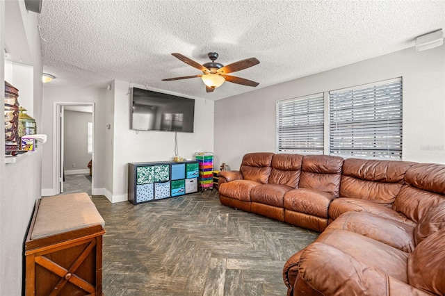 4735 W Leila Ave, Tampa, FL 33616 - living room with a ceiling fan, a textured ceiling, healthy amount of natural light, and baseboards