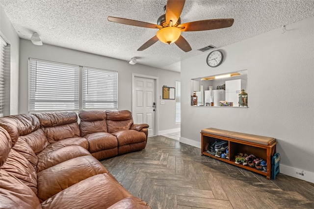 4735 W Leila Ave, Tampa, FL 33616 - living area featuring ceiling fan, plenty of natural light, baseboards, and a textured ceiling