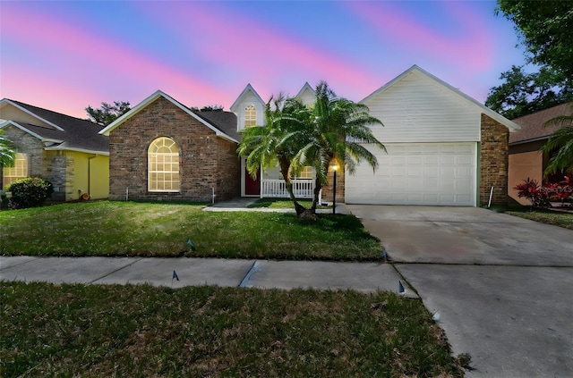 9709 Bay Colony Dr, Riverview, FL 33578 - view of front of home featuring concrete driveway, an attached garage, a front lawn, and brick siding