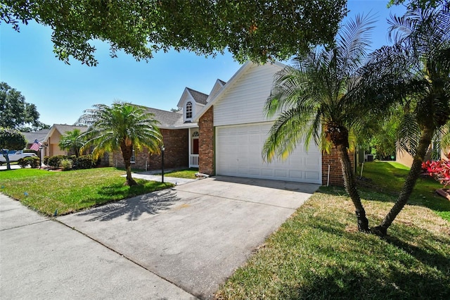 9709 Bay Colony Dr, Riverview, FL 33578 - view of front of house featuring driveway, an attached garage, brick siding, and a front lawn