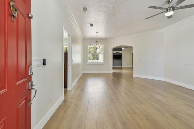9709 Bay Colony Dr, Riverview, FL 33578 - entrance foyer with ceiling fan, ornamental molding, arched walkways, a textured ceiling, and light wood-type flooring