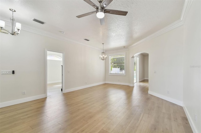 9709 Bay Colony Dr, Riverview, FL 33578 - spare room with a chandelier, arched walkways, a ceiling fan, ornamental molding, and light wood-type flooring