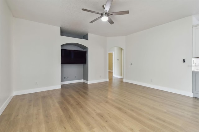 9709 Bay Colony Dr, Riverview, FL 33578 - spare room with ceiling fan, arched walkways, light wood finished floors, and baseboards