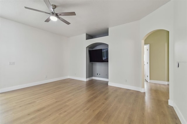 9709 Bay Colony Dr, Riverview, FL 33578 - unfurnished room with a ceiling fan, light wood finished floors, arched walkways, and baseboards