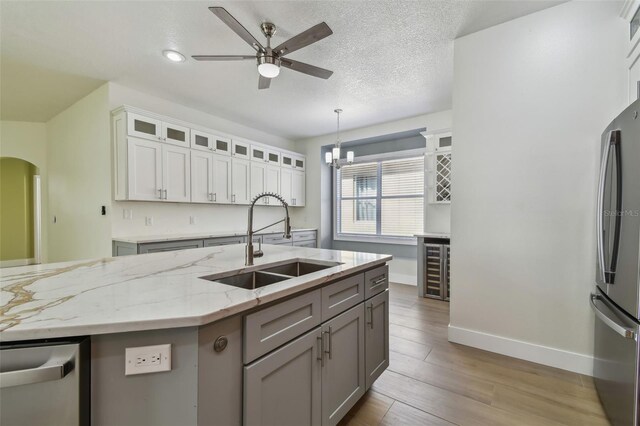 9709 Bay Colony Dr, Riverview, FL 33578 - kitchen featuring a sink, appliances with stainless steel finishes, a ceiling fan, decorative light fixtures, and baseboards