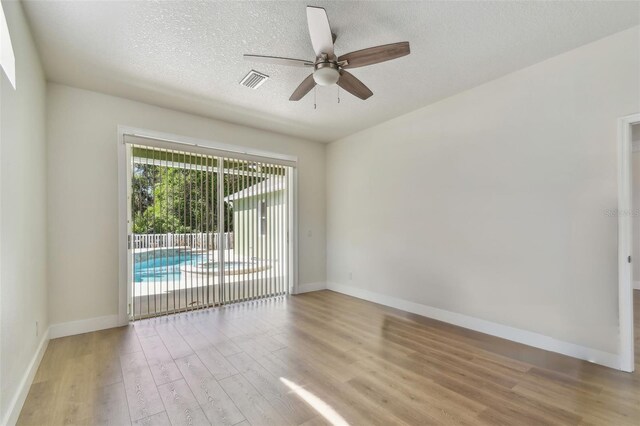 9709 Bay Colony Dr, Riverview, FL 33578 - spare room featuring light wood finished floors, ceiling fan, baseboards, and a textured ceiling