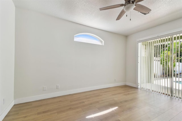 9709 Bay Colony Dr, Riverview, FL 33578 - empty room featuring light wood-style floors, baseboards, ceiling fan, and a textured ceiling