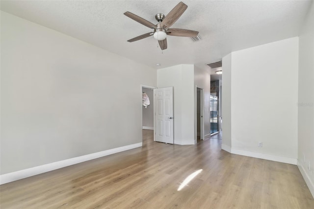 9709 Bay Colony Dr, Riverview, FL 33578 - unfurnished room featuring a ceiling fan, light wood-style flooring, baseboards, and a textured ceiling