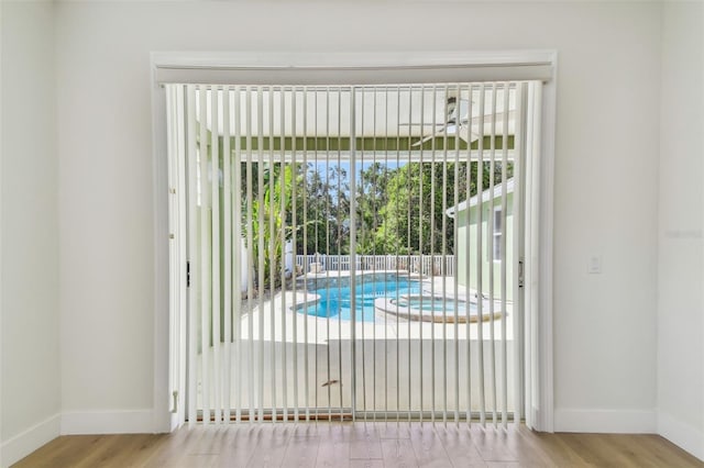 9709 Bay Colony Dr, Riverview, FL 33578 - doorway to outside featuring baseboards, wood finished floors, and a ceiling fan
