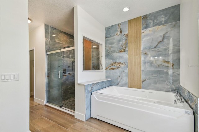 9709 Bay Colony Dr, Riverview, FL 33578 - full bathroom with a bath, a shower stall, wood finished floors, and recessed lighting
