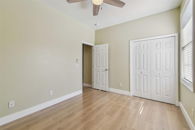 9709 Bay Colony Dr, Riverview, FL 33578 - unfurnished bedroom featuring light wood-type flooring, a closet, baseboards, and ceiling fan
