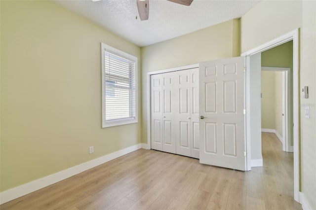 9709 Bay Colony Dr, Riverview, FL 33578 - unfurnished bedroom with light wood-type flooring, a closet, baseboards, and a ceiling fan