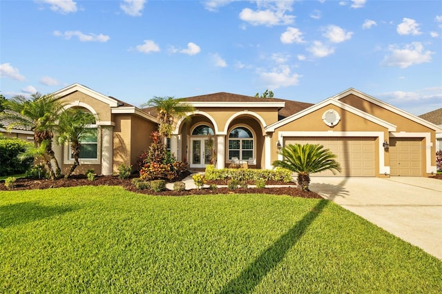 12009 Wandsworth Dr, Tampa, FL 33626 - mediterranean / spanish-style house with stucco siding, concrete driveway, an attached garage, a front yard, and french doors