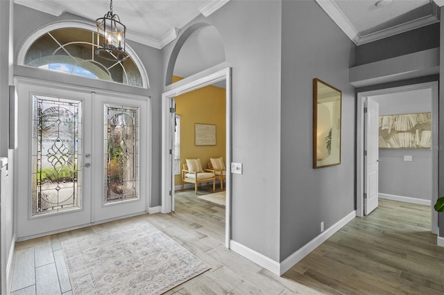 12009 Wandsworth Dr, Tampa, FL 33626 - entrance foyer with crown molding, a chandelier, wood finished floors, and baseboards