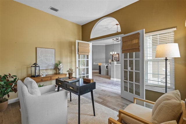 12009 Wandsworth Dr, Tampa, FL 33626 - living area with a chandelier, wood finished floors, and plenty of natural light