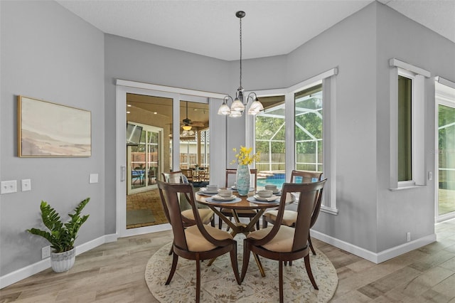 12009 Wandsworth Dr, Tampa, FL 33626 - dining room with light wood-style flooring, baseboards, and a chandelier