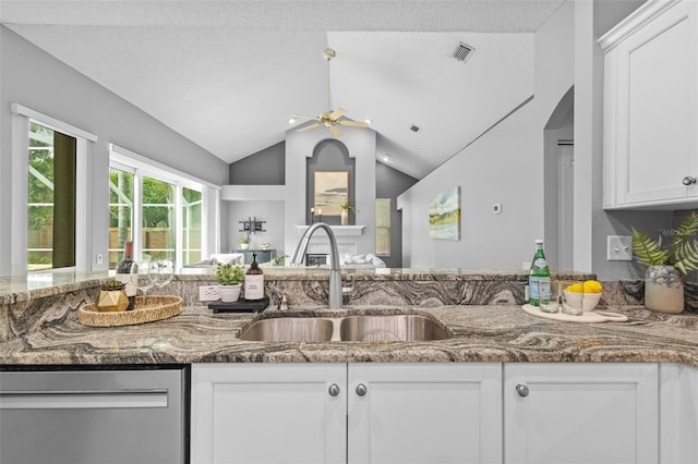 12009 Wandsworth Dr, Tampa, FL 33626 - kitchen featuring stainless steel dishwasher, a sink, ceiling fan, dark stone countertops, and white cabinets