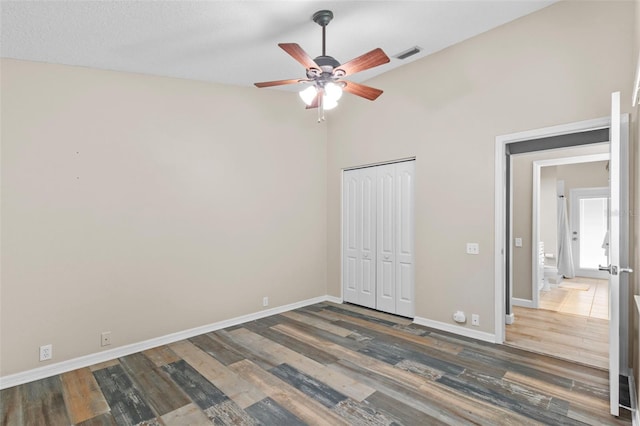 12009 Wandsworth Dr, Tampa, FL 33626 - unfurnished bedroom with baseboards, wood finished floors, a closet, lofted ceiling, and ceiling fan