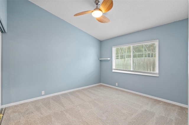 12009 Wandsworth Dr, Tampa, FL 33626 - empty room with a ceiling fan, vaulted ceiling, carpet flooring, and baseboards