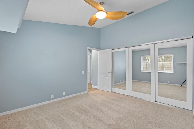 12009 Wandsworth Dr, Tampa, FL 33626 - unfurnished bedroom featuring carpet floors, multiple closets, high vaulted ceiling, baseboards, and a ceiling fan