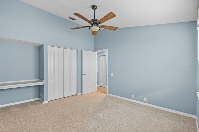 12009 Wandsworth Dr, Tampa, FL 33626 - unfurnished bedroom featuring carpet, baseboards, high vaulted ceiling, a closet, and ceiling fan