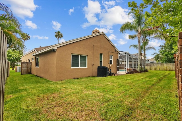 12009 Wandsworth Dr, Tampa, FL 33626 - rear view of property with stucco siding, glass enclosure, a pool, and central air condition unit