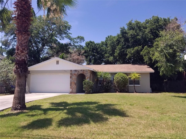 1841 Georgia Ave, Palm Harbor, FL 34683 - single story home with a garage, concrete driveway, a front lawn, and stone siding