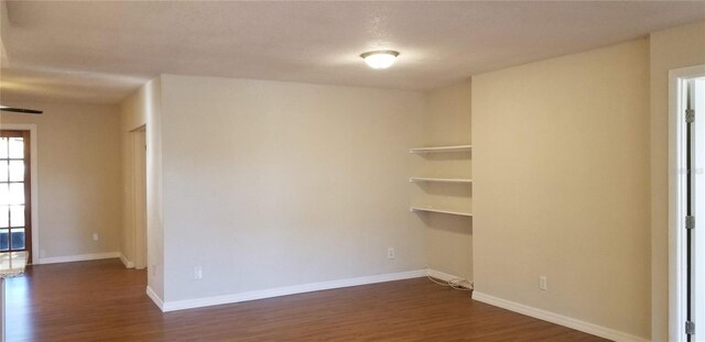 1841 Georgia Ave, Palm Harbor, FL 34683 - spare room featuring dark wood-type flooring and baseboards