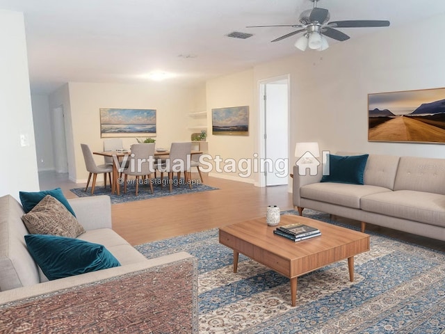 1841 Georgia Ave, Palm Harbor, FL 34683 - living area with ceiling fan, wood finished floors, and baseboards