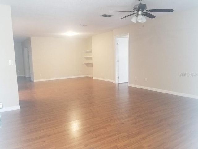 1841 Georgia Ave, Palm Harbor, FL 34683 - unfurnished room with a ceiling fan, light wood-style flooring, and baseboards
