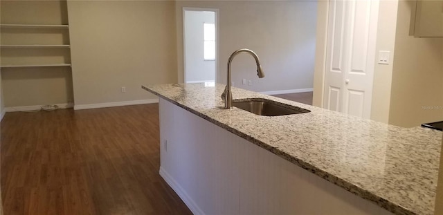 1841 Georgia Ave, Palm Harbor, FL 34683 - kitchen featuring a sink, dark wood-style floors, light stone countertops, and baseboards