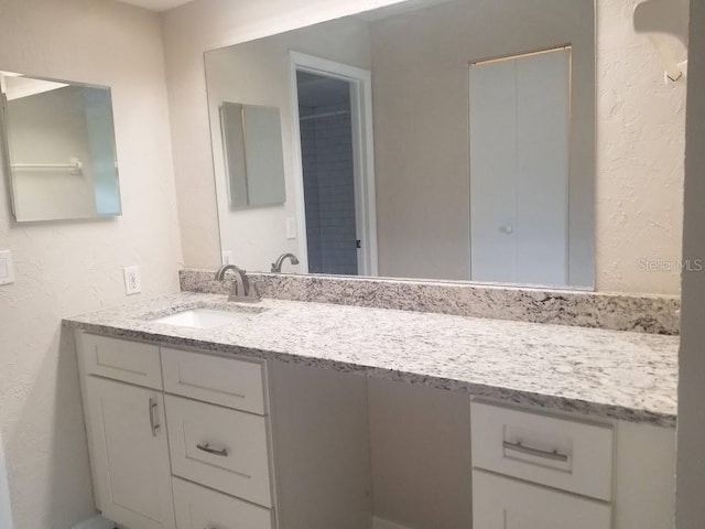 1841 Georgia Ave, Palm Harbor, FL 34683 - bathroom with vanity and a textured wall