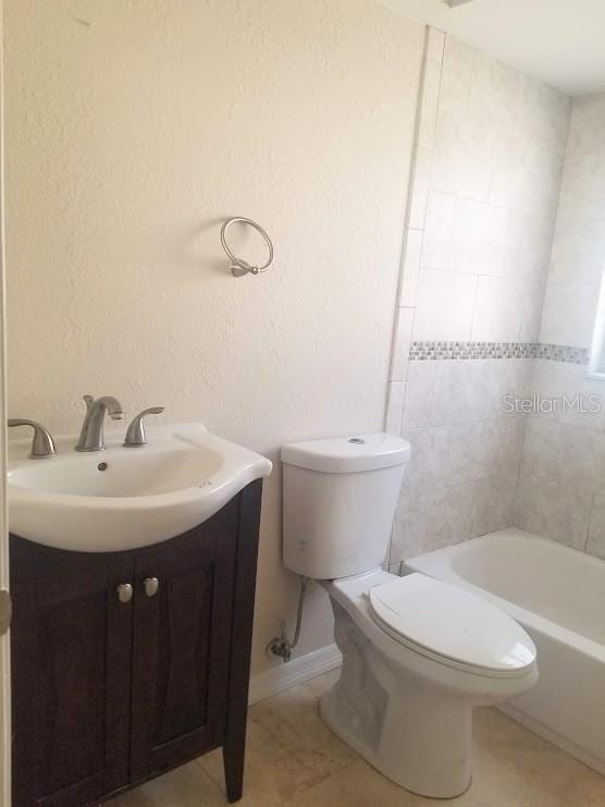 1841 Georgia Ave, Palm Harbor, FL 34683 - full bath with toilet, vanity, tile patterned flooring, and tub / shower combination